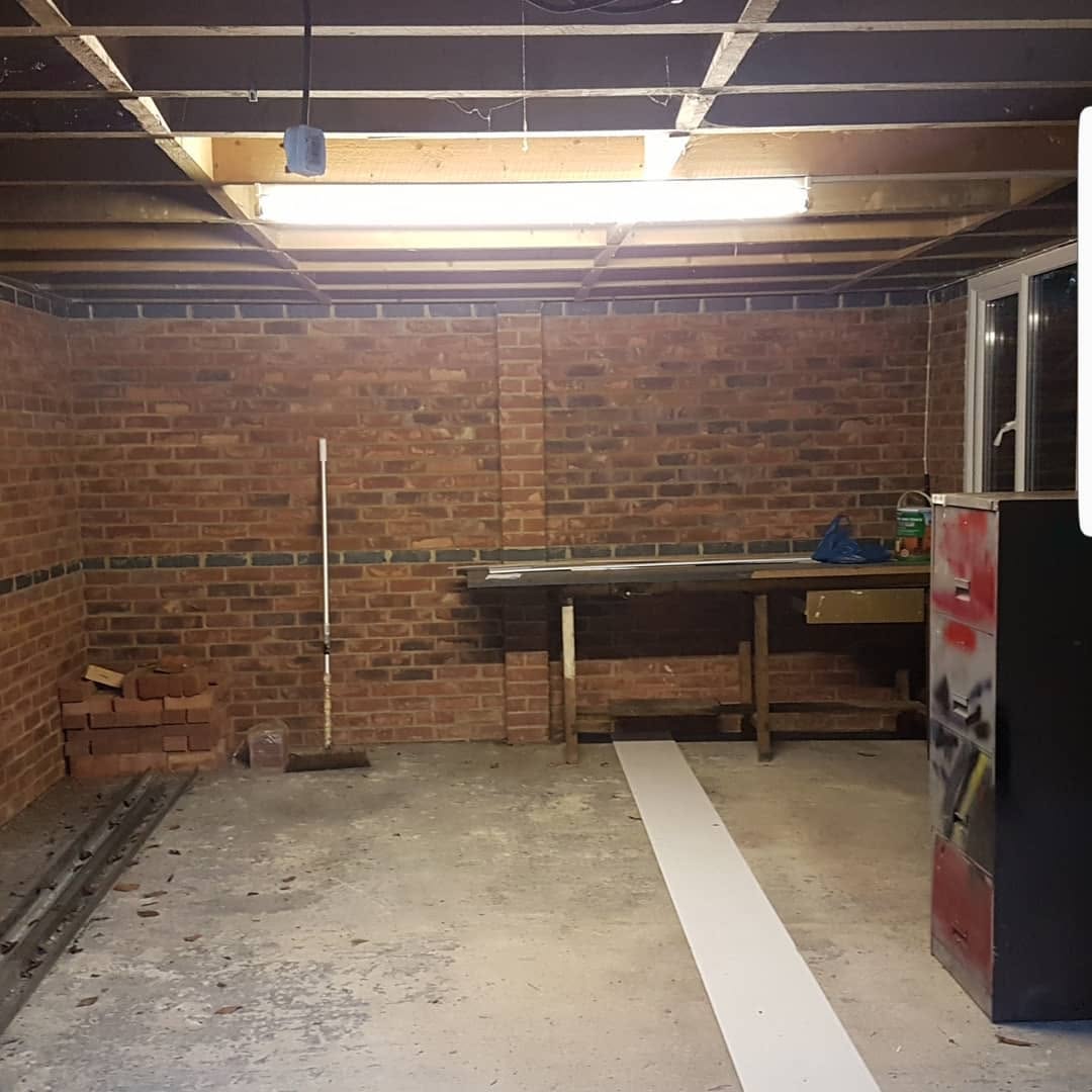 Brick garage interior before conversion to a gym, Surrey