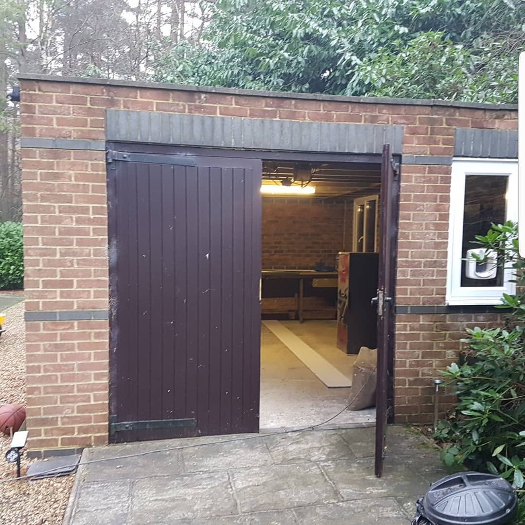 Brick garage before conversion to a gym with shower room, Surrey
