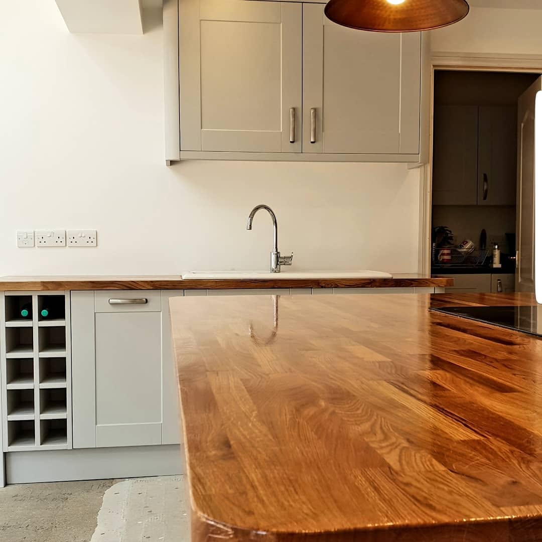 Kitchen with solid timber worktop and shaker units by ADO Builders, Surrey